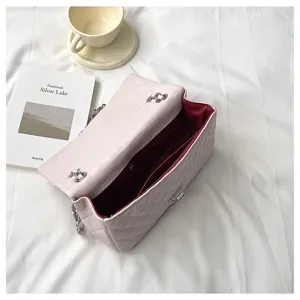 Classic pink quilted chain shoulder bag with metal lock and spacious interior design.