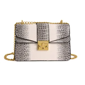 Chic women's crossbody bag with crocodile pattern, metal chain, and stylish lock closure.