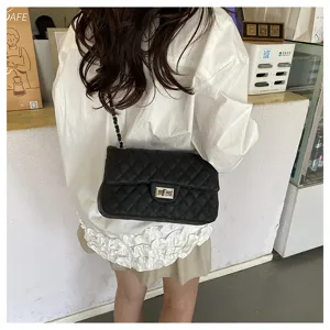 Black quilted chain shoulder bag detail shot, showing classic flap and metal twist lock.
