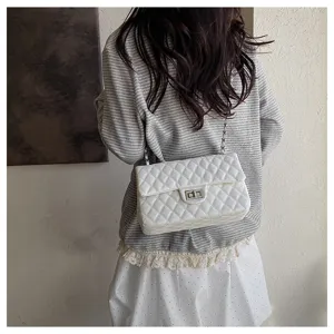 White quilted chain shoulder bag for women, stylish crossbody bag with metal lock.