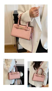 Detailed view of the pink woven texture women handbag with gold metal lock and shoulder strap.