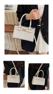 Detailed showcase of stylish contrast woven handbag featuring metal lock and shoulder strap.