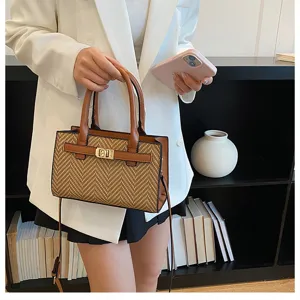 Detailed shot of trendy contrast color woven shoulder bag with metal lock closure and strap.