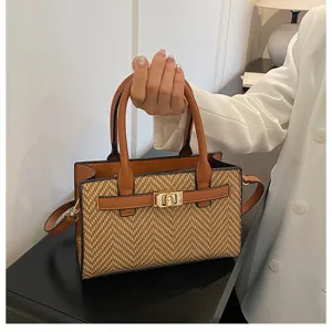 Detailed close-up view of the stylish woven contrast shoulder bag with elegant metal lock closure.