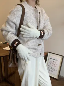 Detailed view of women's knit touch screen gloves with contrast color brown cuffs and logo.
