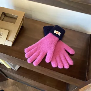 Detailed close-up of colorful knit touchscreen gloves with warm long cuffs for autumn and winter.