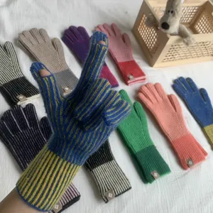 Detailed view of color-blocked knitted fingerless gloves, showcasing texture and vivid tones.