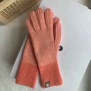 Cozy color-block knitted gloves for women, stylish and warm for autumn and winter seasons.