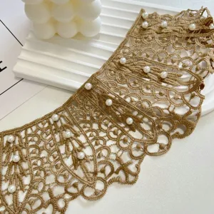 Khaki lace collar detail shot featuring delicate pearl embellishments and intricate woven mesh texture.