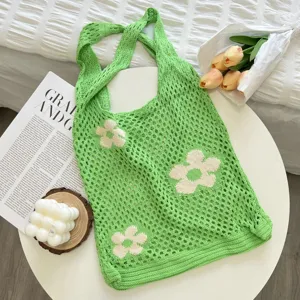 Green crochet tote bag with white flower pattern, hollow knit design for casual daily use.