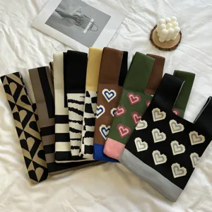 Knit tote bag with chic heart and stripe patterns, trendy color block casual knitted handbag.