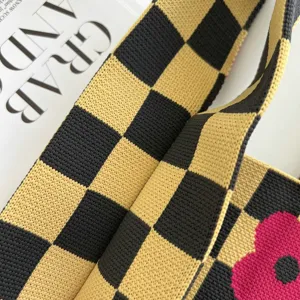 Stylish checkerboard knitted tote bag for women with vibrant yellow and dark tones.