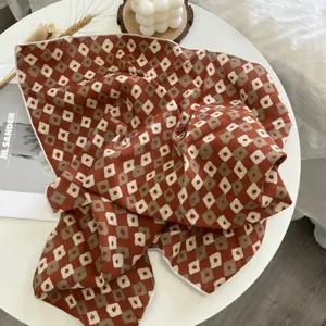 Détail de carré en coton à motif géométrique floral rouge et brun, foulard et bandeau élégants.