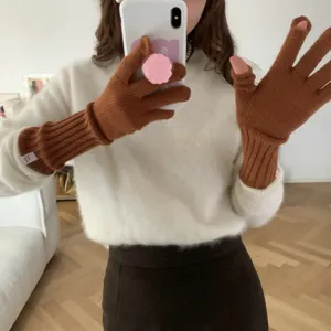 Detailed shot of cozy solid color knitted fingerless gloves for winter daily wear.