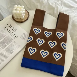 Brown knitted tote bag featuring blue white heart patterns and contrast color hem daily chic.