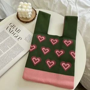 Green knitted tote bag with cute pink heart patterns, stylish casual handbag for daily use.