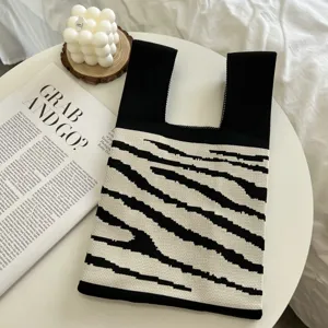 Zebra pattern knitted tote bag detail showing woven texture and black white contrast design.