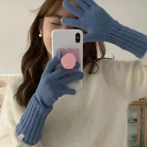 Detail shot of blue knit fingerless gloves, cozy wool material, comfortable winter wear.