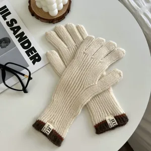 Guantes de punto elegantes para mujer en crema con puños marrones, cálidos para el invierno.