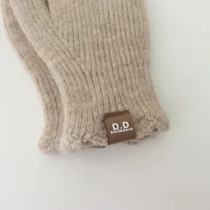 Knit winter touch screen gloves with cute ruffles and branding leather patch, cozy and warm.