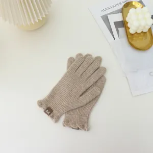 Detailed view of women knit winter gloves featuring cute ruffles and soft warm texture.