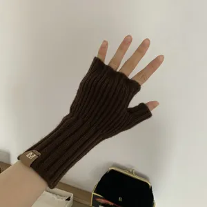 Brown knitted fingerless gloves detail view, winter warm half-finger wrist warmer for women.