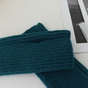Dark teal knitted fingerless gloves for winter, cozy short arm warmers for writing typing.
