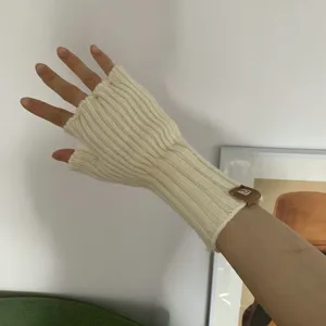 Closeup detail of women knitted fingerless gloves solid color warm wrist warmer design