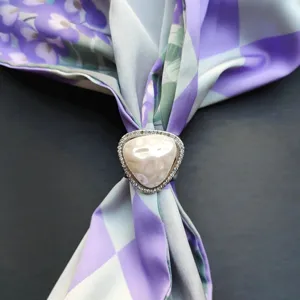 Exquisite triangular rhinestone scarf ring detail, elegant silk scarf buckle accessory.