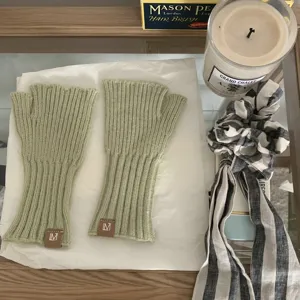 Green knit fingerless gloves detail view, winter warm ribbed arm warmers for women.