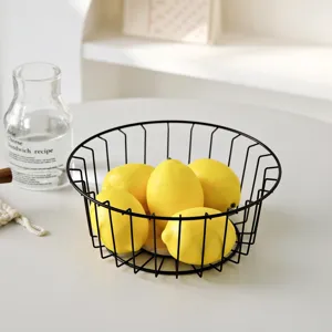 Nordic black metal wire fruit basket with yellow lemons for modern living room snack storage