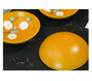 Hand-painted floral wooden fruit plate detail showcasing exquisite craftsmanship and natural finish.