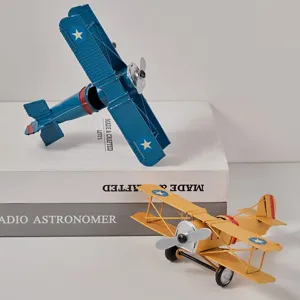 Vintage metal biplane model, retro handcrafted airplane toy for home tabletop decor display.