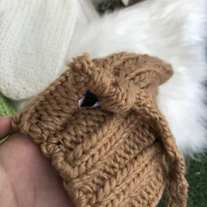 Close-up of thick knit winter gloves detail, soft brown wool texture, cozy student accessory.