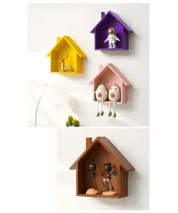 Detailed view of creative wooden house wall shelves displaying cute decorative animal figurines.