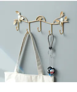 Nordic gold metal wall hook detail, leaf branch design coat rack, entryway key holder display.