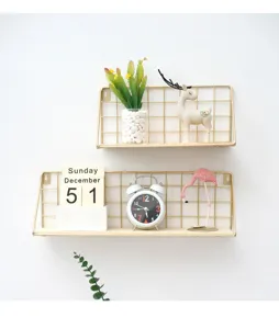 Gold wire wall shelf detail view, metal hanging storage basket with wooden base for home decor.