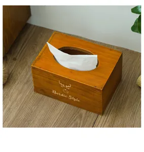 Wooden tissue box detail showing retro vintage design with Nordic style deer logo on surface.