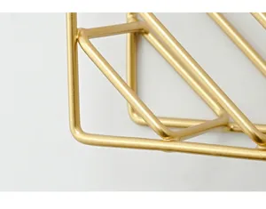 Nordic gold iron wall mounted bookshelf detail shot, geometric metal wire storage rack texture