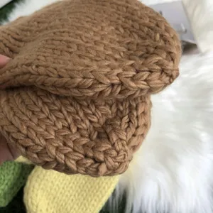 Chunky knit glove detail showcasing thick textured wool material and cozy winter warm design.