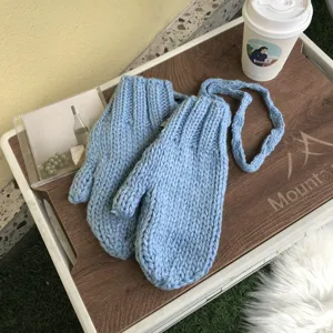 Chunky knit winter mittens for women, cute light blue thick thermal gloves with hanging neck strap.