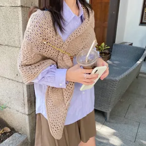 Knitted triangular shawl scarf with chain detail, stylish autumn winter outerwear piece.