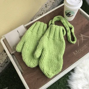 Chunky knit winter gloves with convenient neck strap, cozy green warm mittens for cold days.