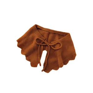 Brown knitted fake collar with ruffled scalloped edges and stylish bow tie closure.