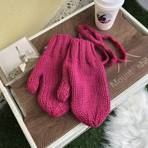 Cute thick knit pink mittens for women and girls, warm winter string gloves with soft texture.