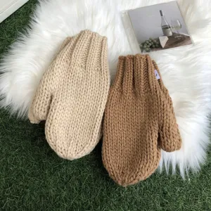 Warm thick knit winter mittens in beige and brown, cozy wool gloves for cold weather styling.