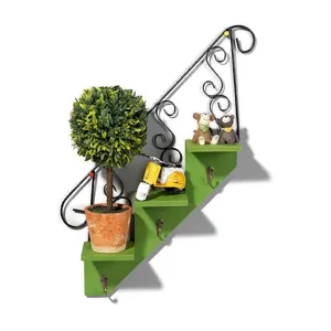 Decorative wall-mounted staircase shelf with hooks, plant, and cute figurines for living room.