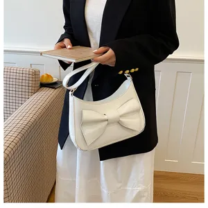 Stylish white bow shoulder bag detail view, chic underarm handbag for women daily fashion wear.