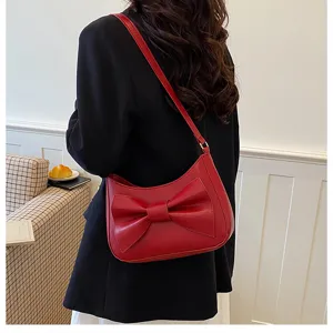 Red bow shoulder bag for women, stylish underarm hobo bag, versatile fashion accessory.
