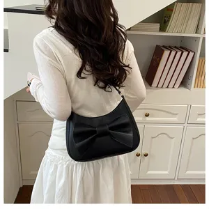 Elegant black shoulder bag for women featuring a stylish large bow design and chic look.
